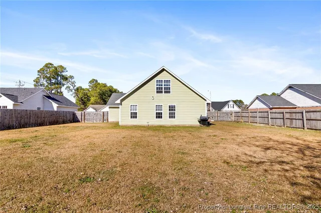 a view of a house with a yard and potted plants