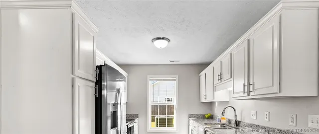 a kitchen with stainless steel appliances granite countertop a refrigerator and sink