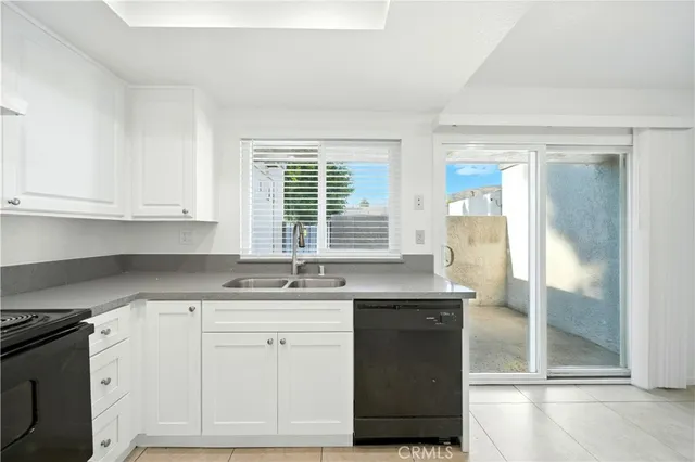 a kitchen with granite countertop a sink and a stove