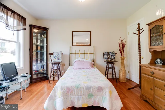 a living room with furniture large window and wooden floor