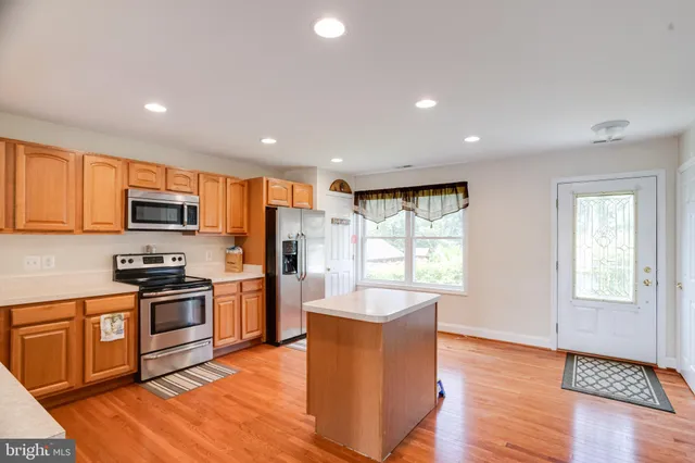 a large living room with furniture and a wooden floor