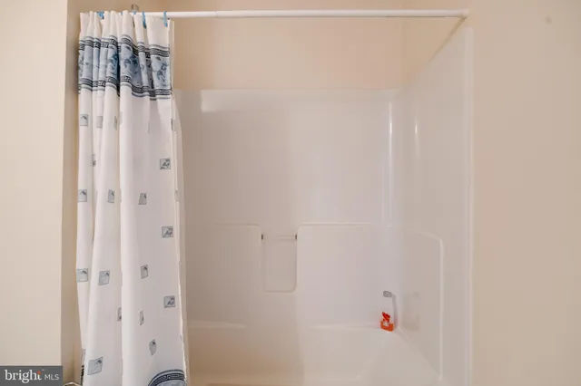 a living room with furniture and large windows