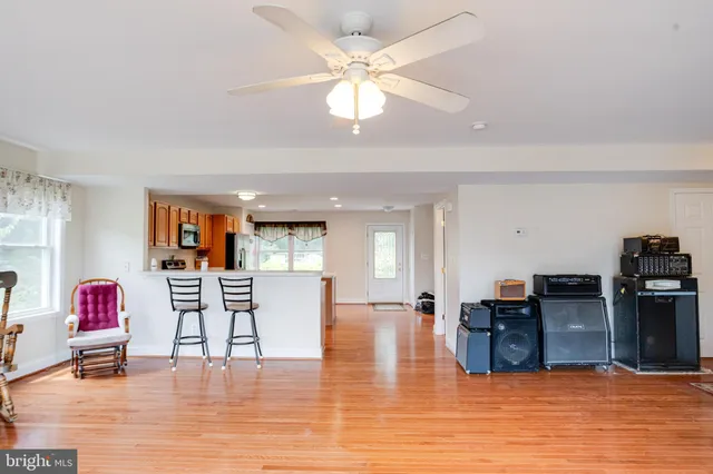 a bathroom with a tub a sink and a large mirror