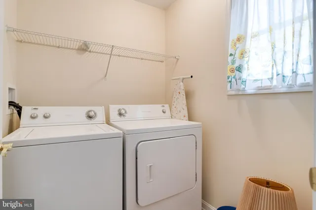 an aerial view of a house with a garden and lake view