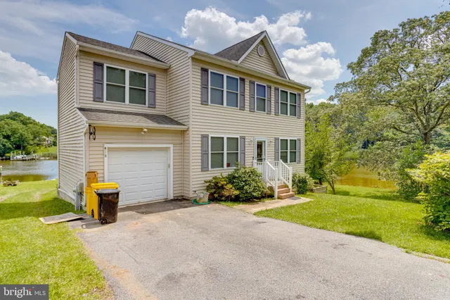 an aerial view of a house with a garden and lake view