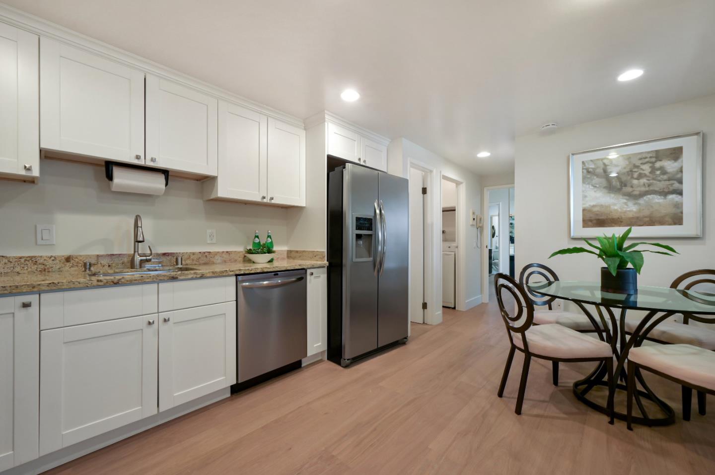 110 Park Road, Unit 502 Burlingame, CA 94010 - Photo 13 of 43 a kitchen with stainless steel appliances granite countertop a refrigerator and a stove top oven