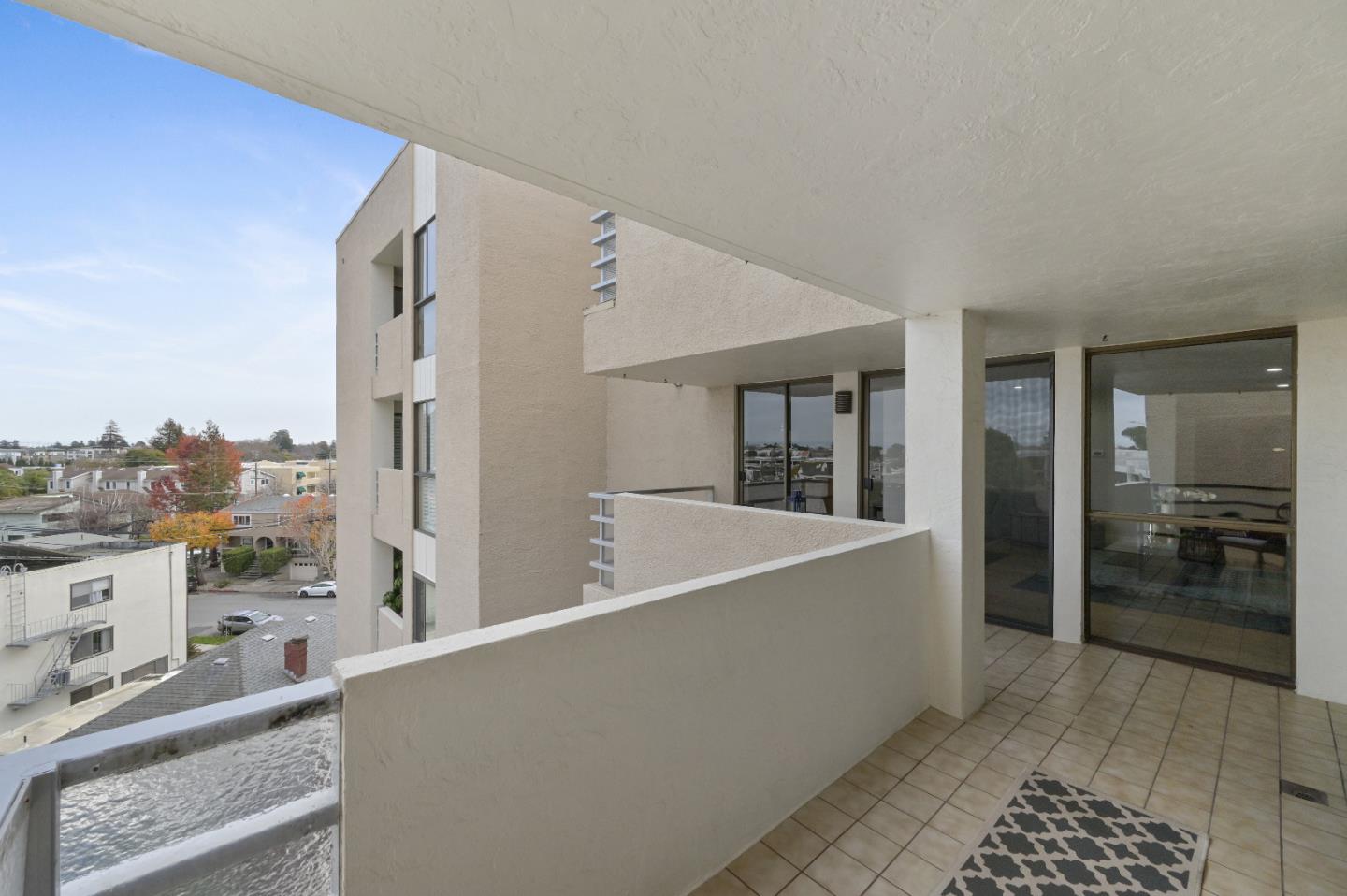 110 Park Road, Unit 502 Burlingame, CA 94010 - Photo 18 of 43 a living room with furniture a ceiling fan and a rug