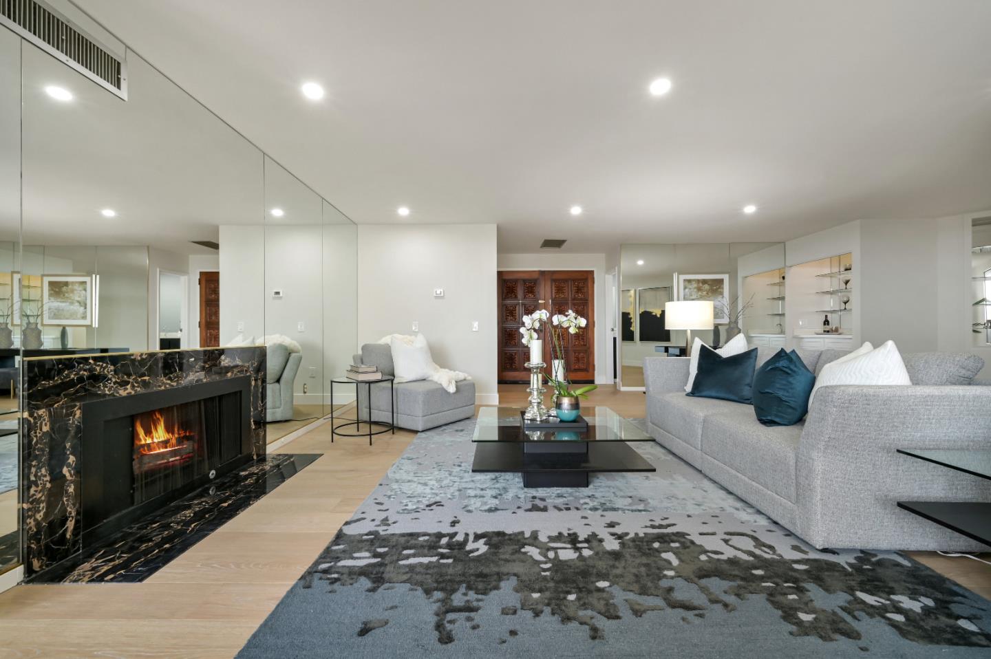 110 Park Road, Unit 502 Burlingame, CA 94010 - Photo 3 of 43 a living room with furniture a fireplace and a dining table with wooden floor