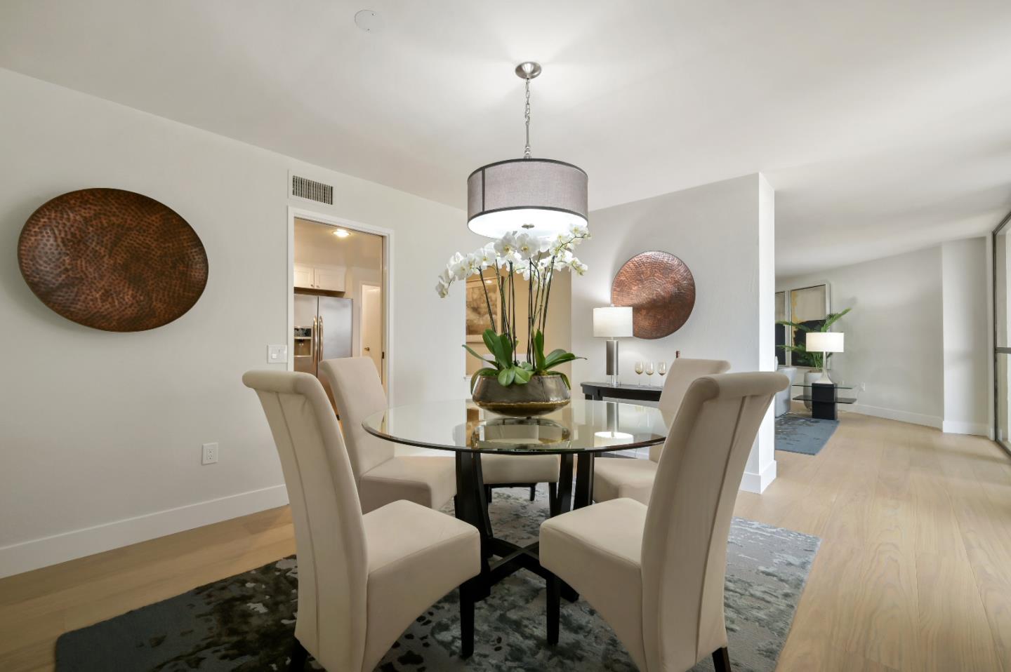 110 Park Road, Unit 502 Burlingame, CA 94010 - Photo 9 of 43 a dining room with furniture and wooden floor