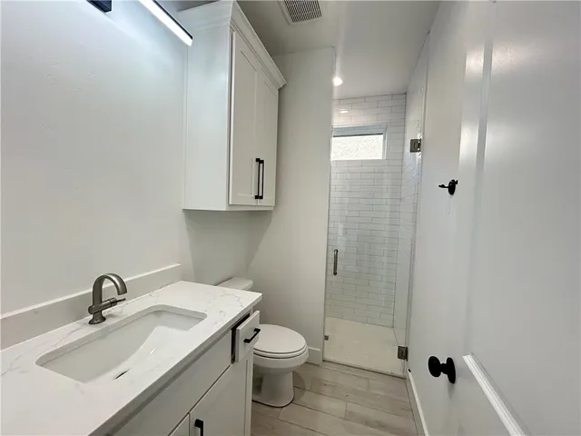 a bathroom with a sink toilet and shower