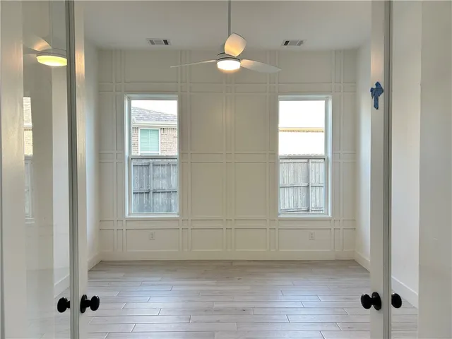 an empty room with windows and closet