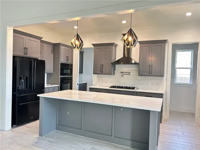 a kitchen with stainless steel appliances a sink stove and refrigerator