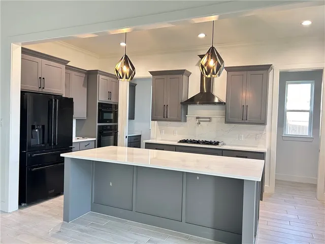 a kitchen with stainless steel appliances a sink stove and refrigerator