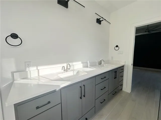 a bathroom with a double vanity sink and a mirror