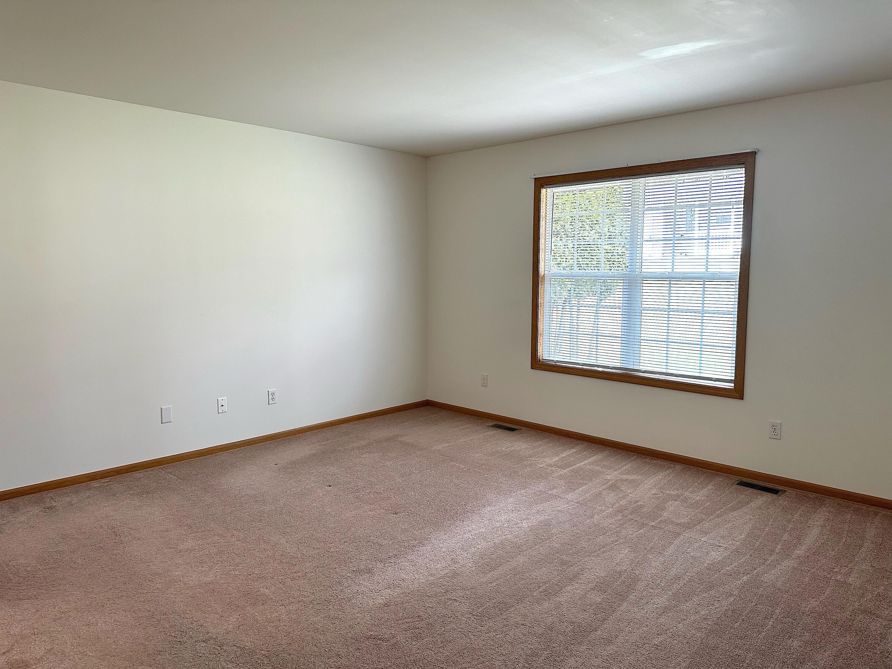 482 Fox Lane Walworth, WI 53184 - Photo 13 of 20 This huge primary suite overlooks the rear yard and has room for all of your favorite bedroom furniture