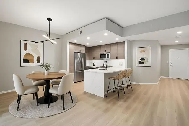 a view of a kitchen with a sink and a large window