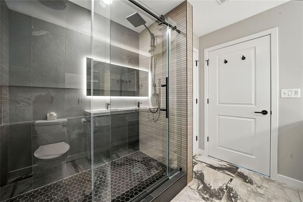 3300 Windy Ridge Parkway Southeast, Unit 711 Atlanta, GA 30339 - Photo 16 of 37 a bathroom with a toilet and a shower