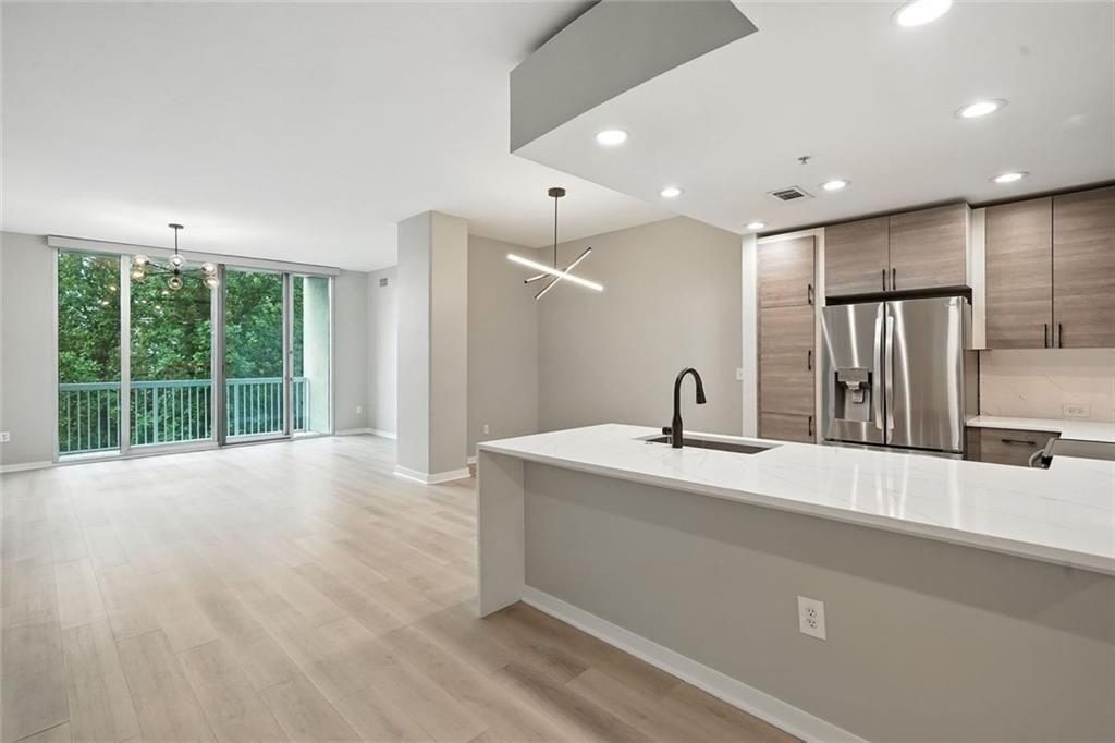 3300 Windy Ridge Parkway Southeast, Unit 711 Atlanta, GA 30339 - Photo 2 of 37 a view of a kitchen with a sink and a large window