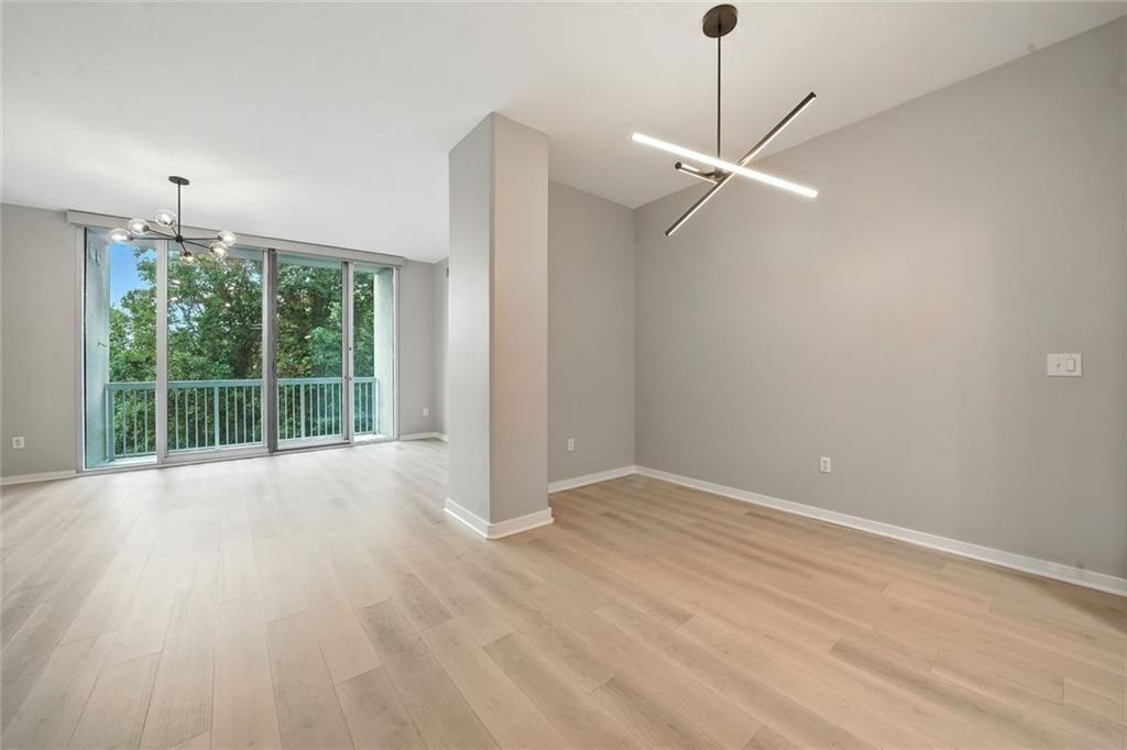 3300 Windy Ridge Parkway Southeast, Unit 711 Atlanta, GA 30339 - Photo 8 of 37 a view of an empty room with a window and wooden floor