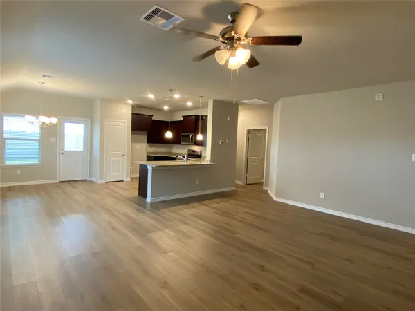 a view of a kitchen with a stove cabinets and wooden floor