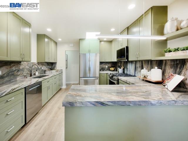 743 Marino Pines Road Pacific Grove, CA 93950 - Photo 11 of 28 a kitchen with kitchen island granite countertop a sink a counter top space and living room area