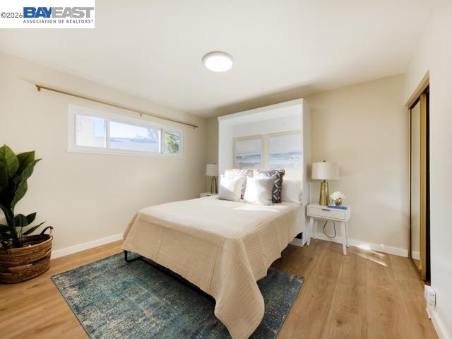 743 Marino Pines Road Pacific Grove, CA 93950 - Photo 16 of 28 a bedroom with a bed and wooden floor
