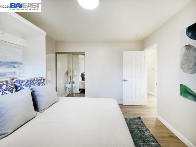 743 Marino Pines Road Pacific Grove, CA 93950 - Photo 17 of 28 a bedroom with a large bed and a potted plant