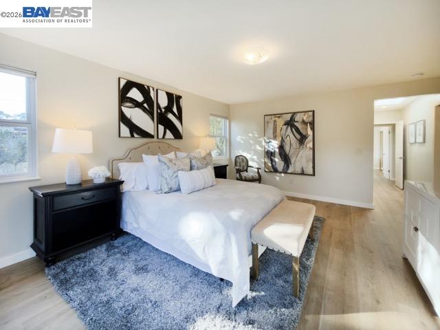 743 Marino Pines Road Pacific Grove, CA 93950 - Photo 21 of 28 a bed room with a bed and a painting on the wall