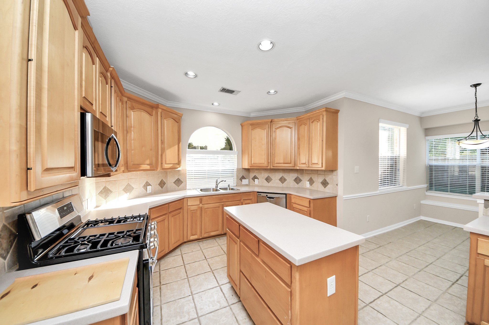 11918 Helene Court Pinehurst, TX 77362 - Photo 12 of 50 a kitchen with a stove a sink and a refrigerator