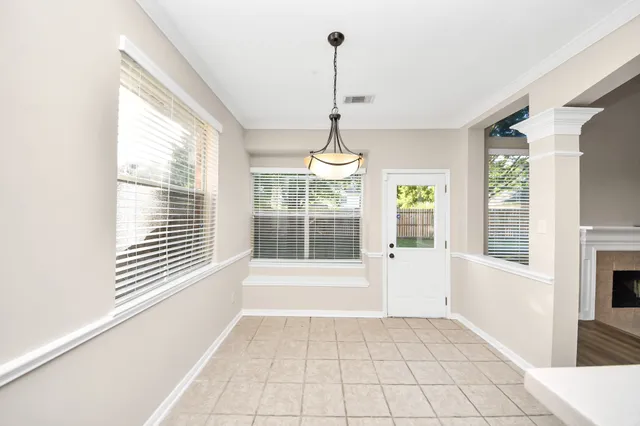 a large kitchen with stainless steel appliances granite countertop a stove and a refrigerator