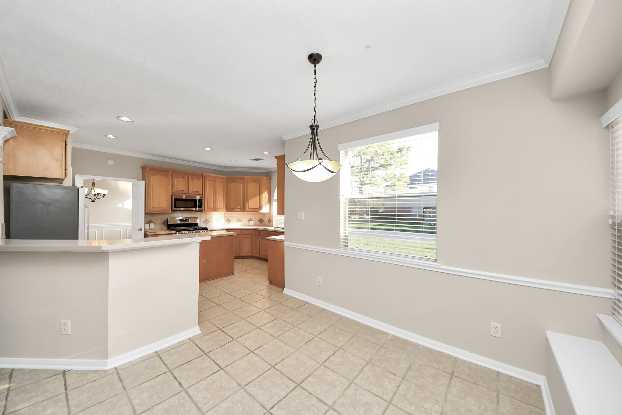 11918 Helene Court Pinehurst, TX 77362 - Photo 21 of 50 a kitchen with white cabinets and window