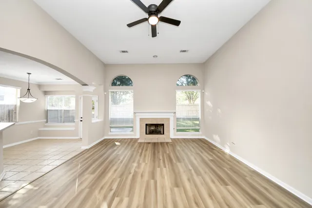wooden floor in an empty room with a fireplace