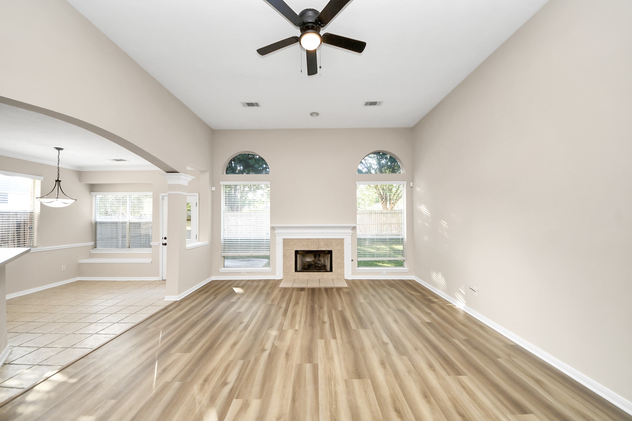 11918 Helene Court Pinehurst, TX 77362 - Photo 26 of 50 a view of a livingroom with wooden floor a ceiling fan and windows