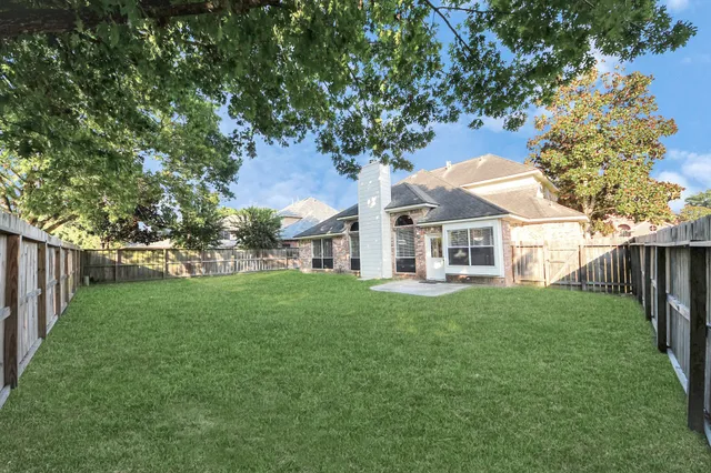 a view of house with backyard