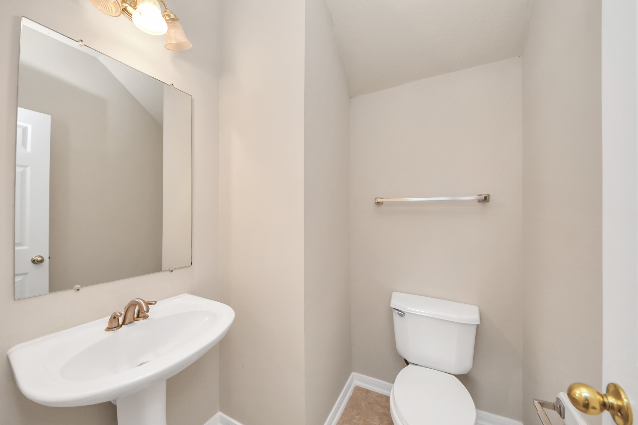 11918 Helene Court Pinehurst, TX 77362 - Photo 32 of 50 a bathroom with a toilet a sink and a mirror