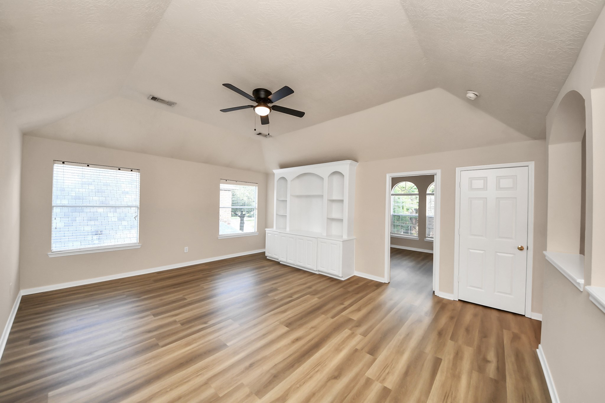 11918 Helene Court Pinehurst, TX 77362 - Photo 34 of 50 a view of an empty room with a window and wooden floor