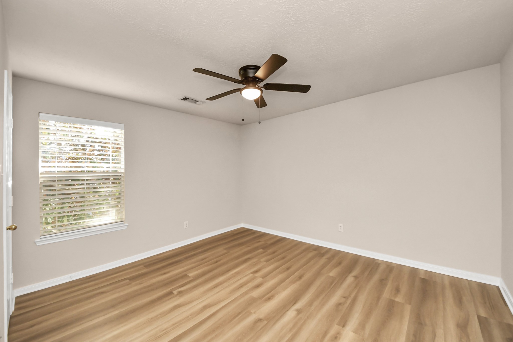 11918 Helene Court Pinehurst, TX 77362 - Photo 38 of 50 a view of empty room with wooden floor and fan