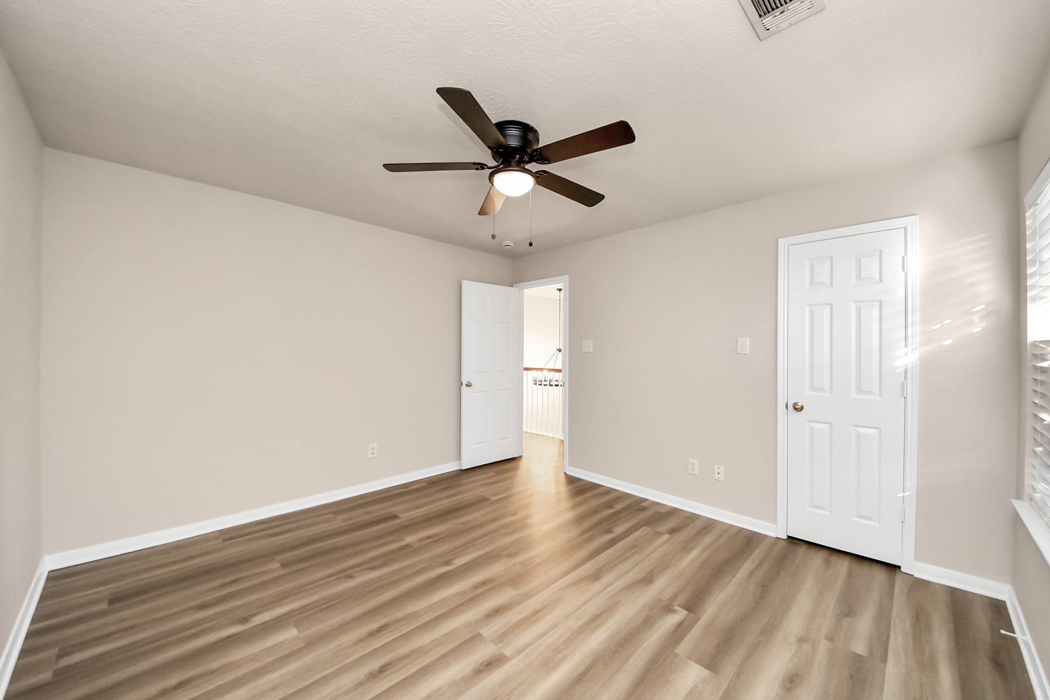 11918 Helene Court Pinehurst, TX 77362 - Photo 40 of 50 a view of a room with wooden floor and a ceiling fan