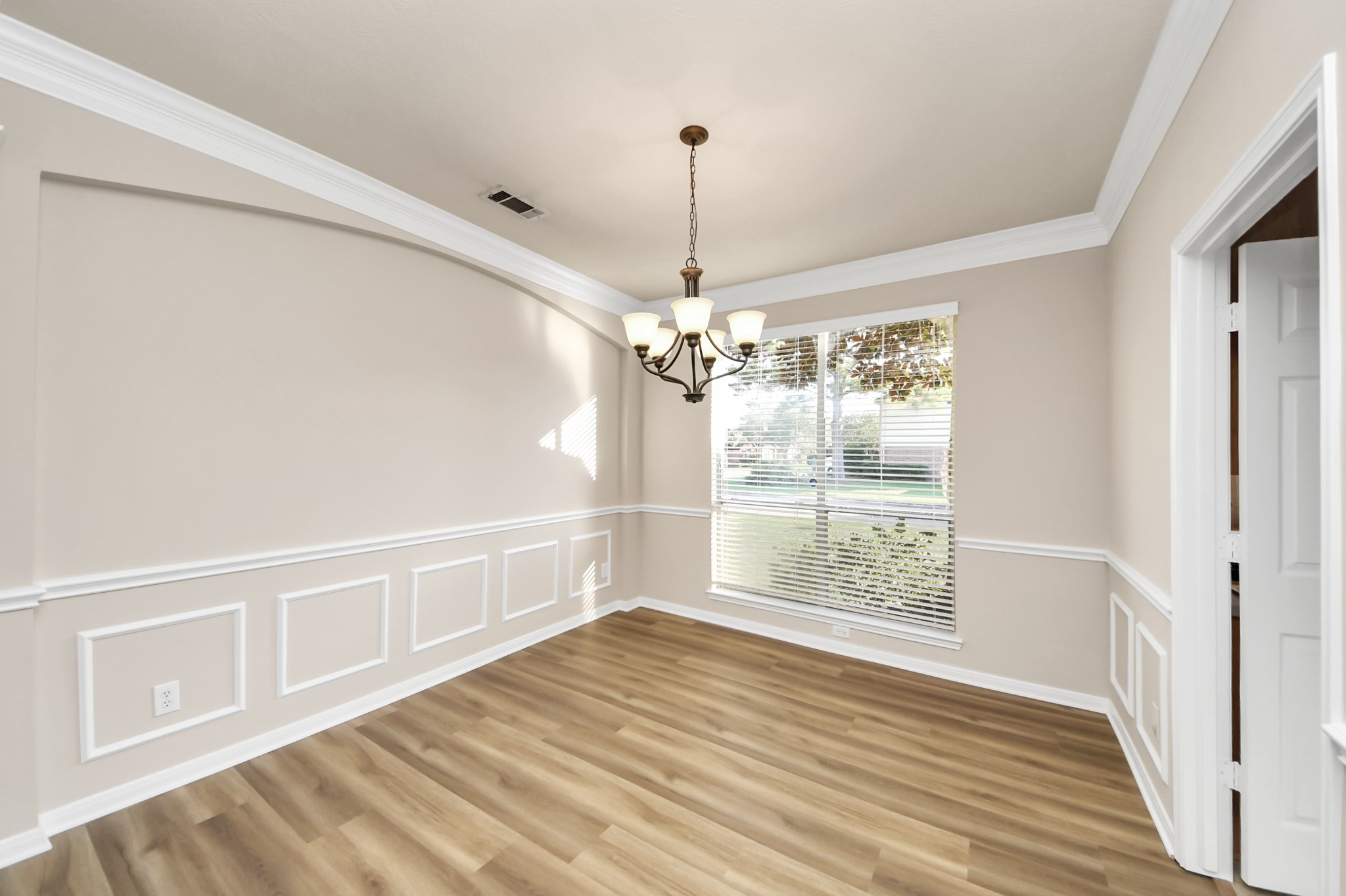 11918 Helene Court Pinehurst, TX 77362 - Photo 9 of 50 a view of an empty room with wooden floor and a window
