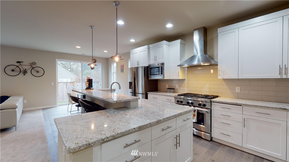 29 175th Place Southeast Bothell, WA 98012 - Photo 2 of 19 a kitchen with stainless steel appliances granite countertop a sink a stove and a refrigerator