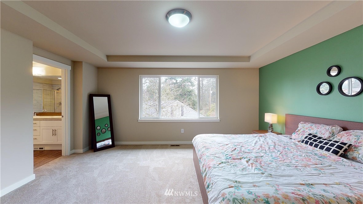 29 175th Place Southeast Bothell, WA 98012 - Photo 13 of 19 a bedroom with a bed and a large window