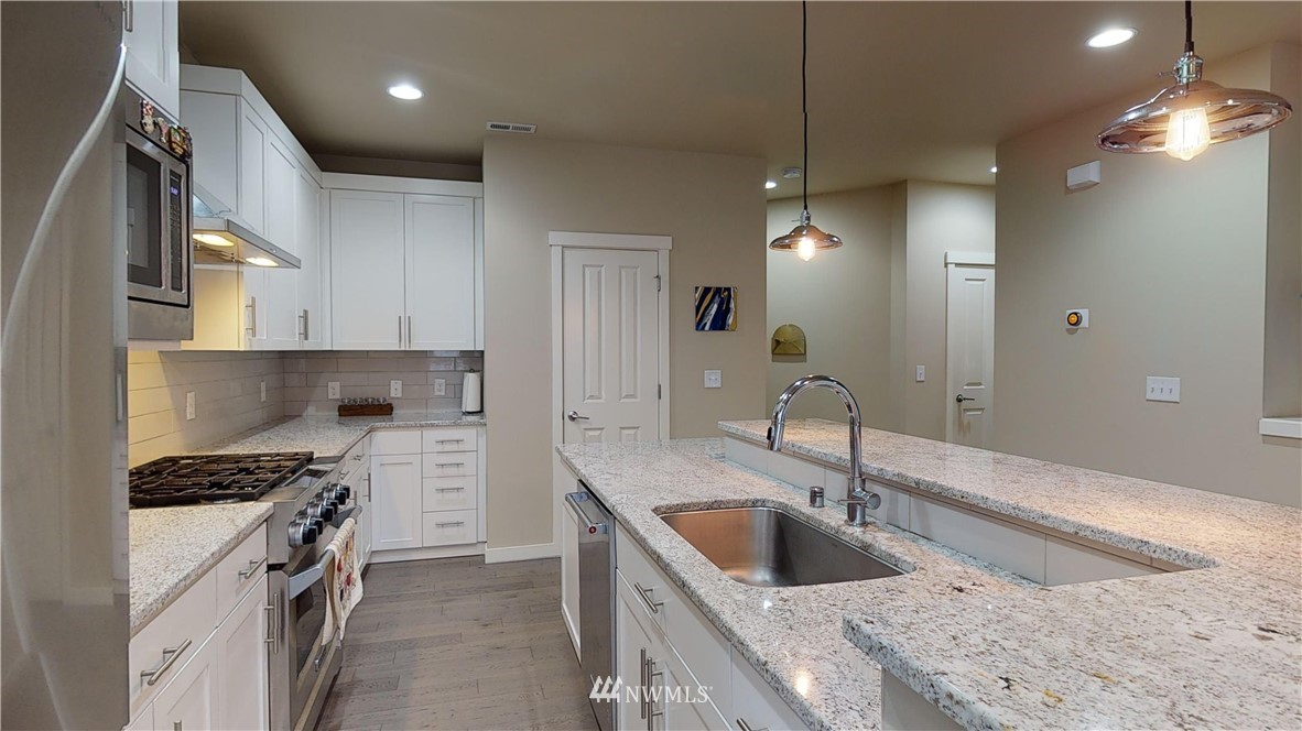 29 175th Place Southeast Bothell, WA 98012 - Photo 4 of 19 a kitchen with a sink stove top oven and cabinets