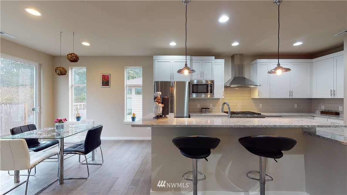 29 175th Place Southeast Bothell, WA 98012 - Photo 5 of 19 a kitchen with a dining table chairs sink and cabinets