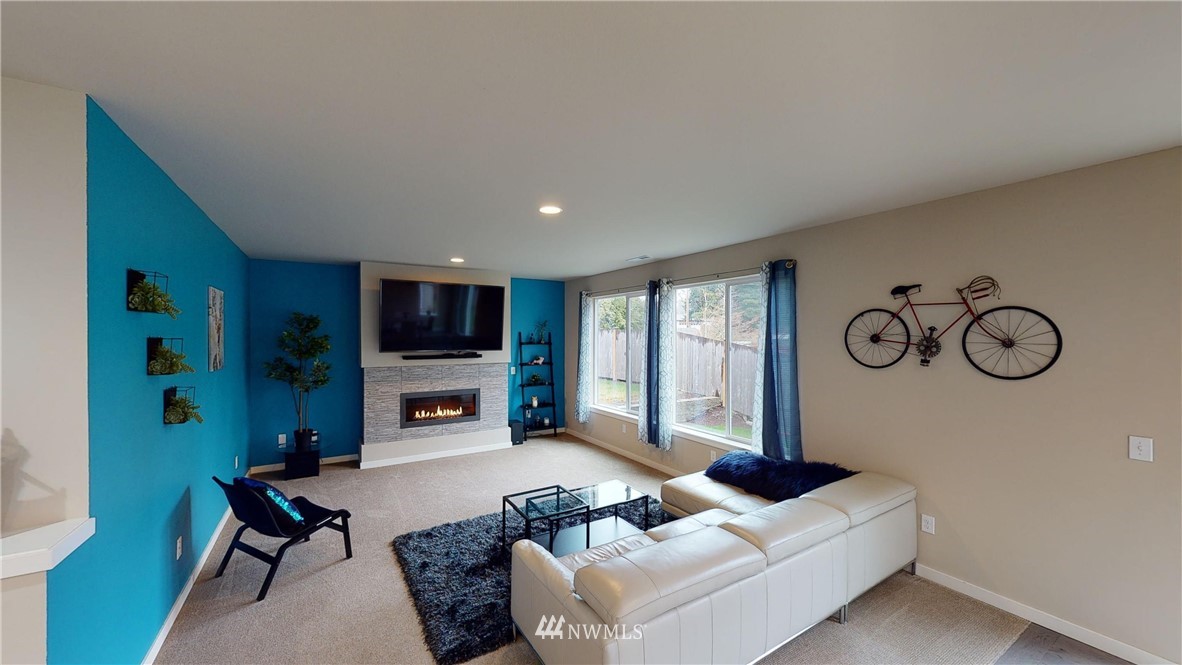29 175th Place Southeast Bothell, WA 98012 - Photo 6 of 19 a living room with furniture a flat screen tv and a wall