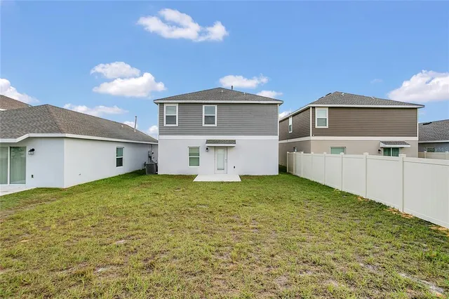 an aerial view of residential houses with outdoor space and swimming pool