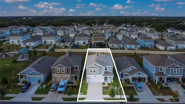 an aerial view of a house with a lake view