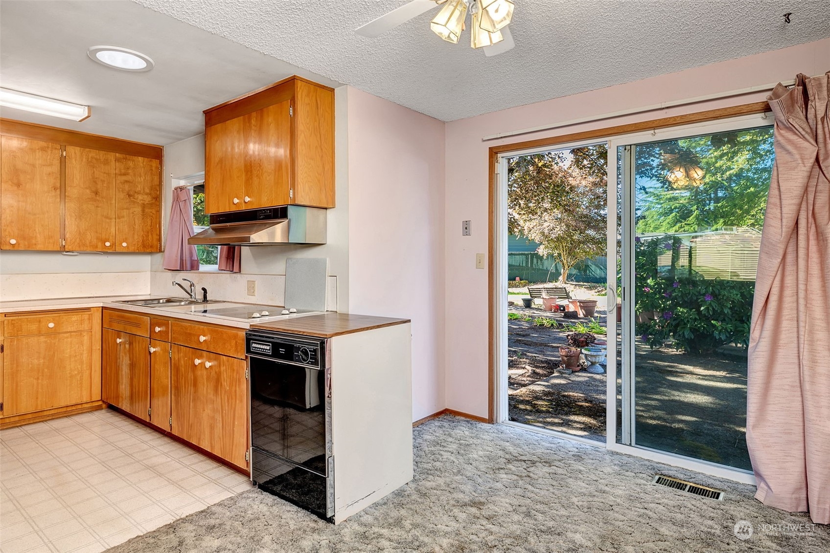 4109 Northeast 10th Place Renton, WA 98059 - Photo 11 of 27 a kitchen with stainless steel appliances granite countertop a stove a sink and a refrigerator