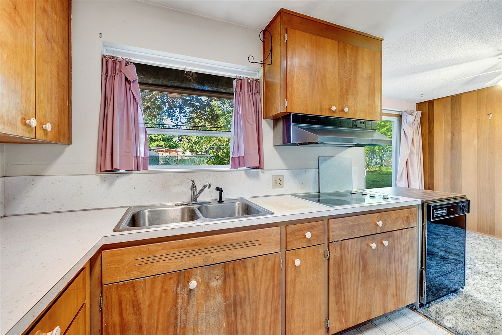 4109 Northeast 10th Place Renton, WA 98059 - Photo 13 of 27 a kitchen with a sink a window and cabinets