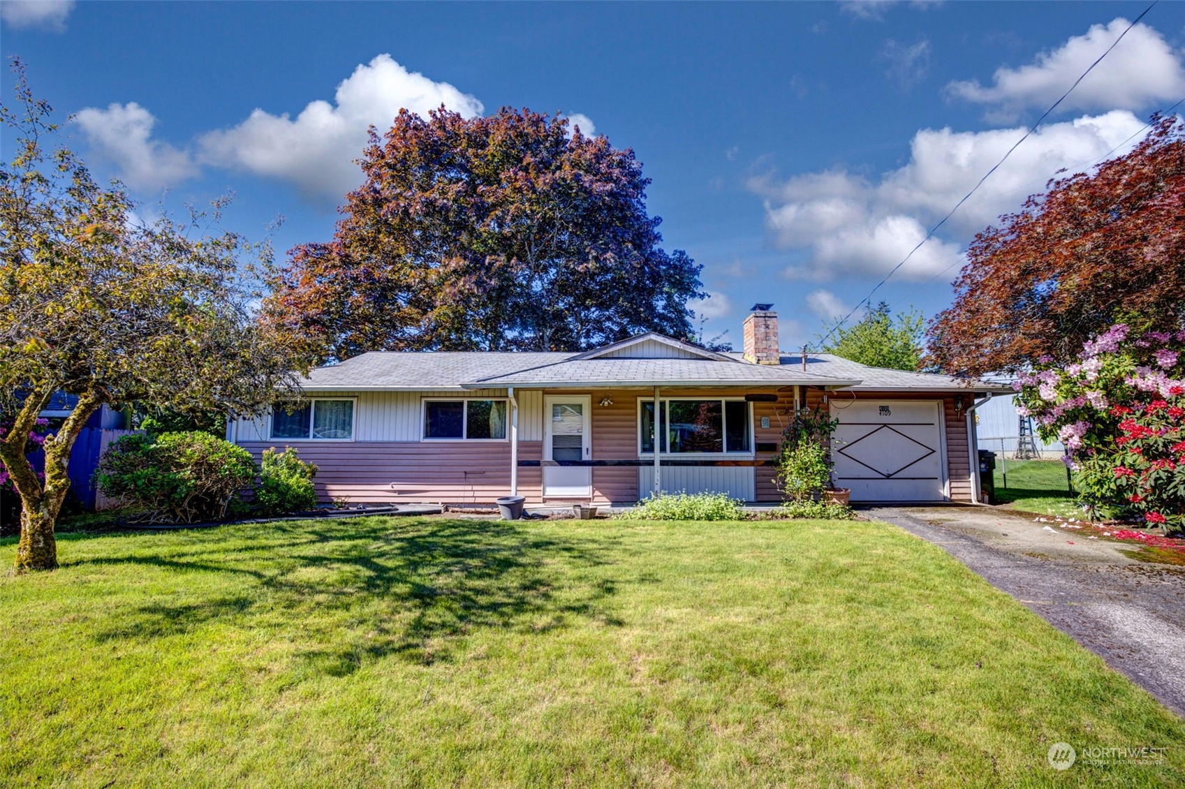 4109 Northeast 10th Place Renton, WA 98059 - Photo 2 of 27 a front view of a house with garden