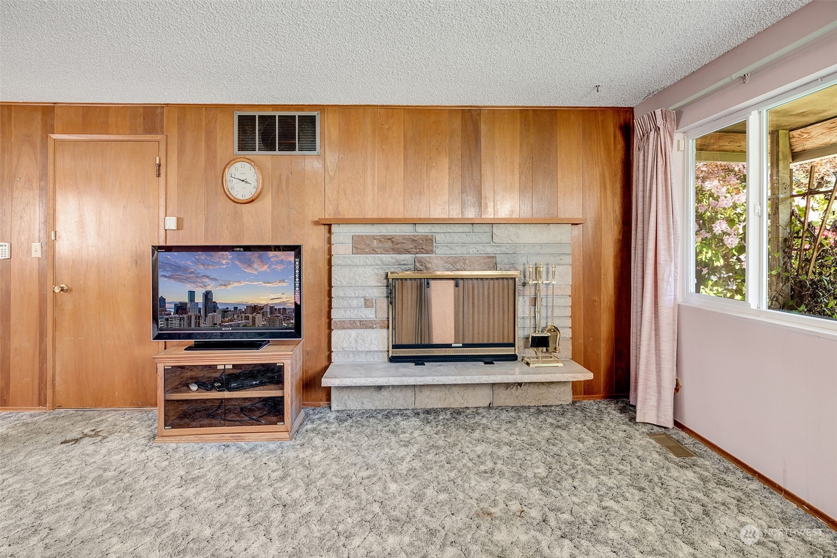 4109 Northeast 10th Place Renton, WA 98059 - Photo 6 of 27 a living room with furniture a fireplace and a flat screen tv